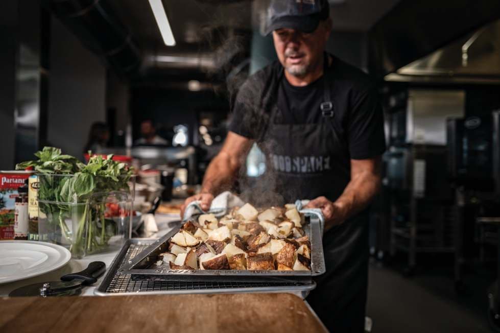 Chef carrying a tray of food